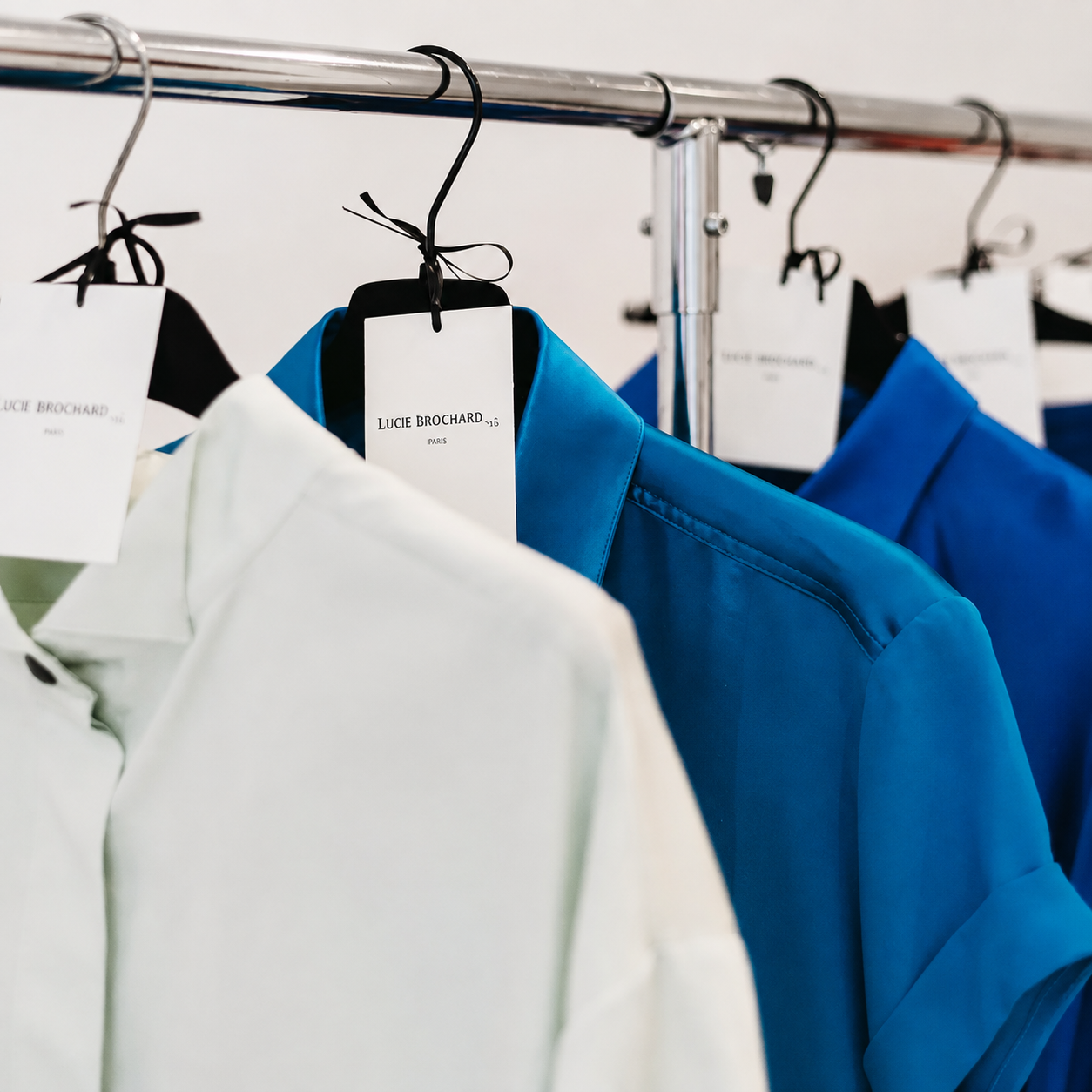 A quiet working moment in the atelier, hands and garment